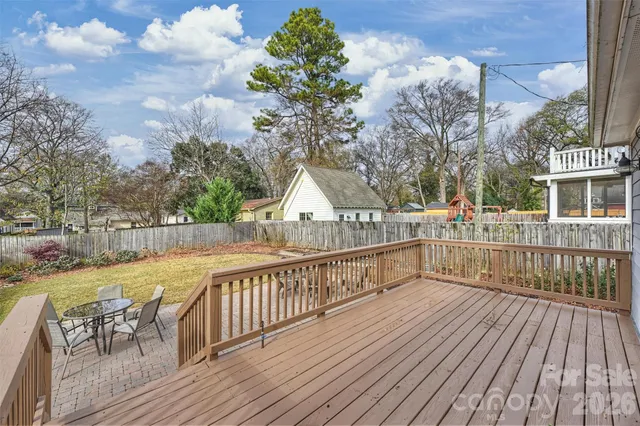 a view of a balcony with wooden floor and seating space