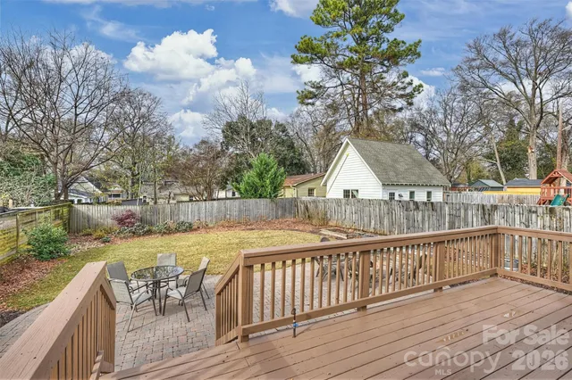 a view of a wooden deck and a yard