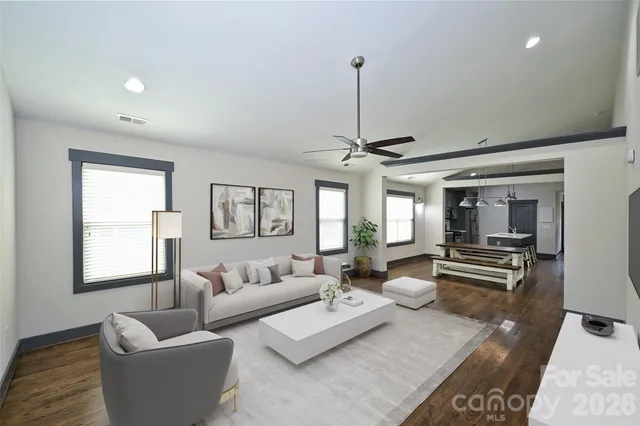 a living room with furniture and a wooden floor