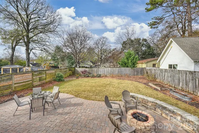 a view of a swimming pool with chair and tables