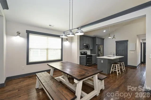 a kitchen with a table and chairs in it