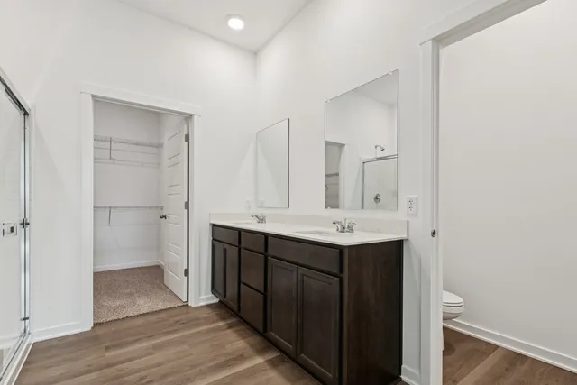 a bathroom with a double vanity sink and mirror