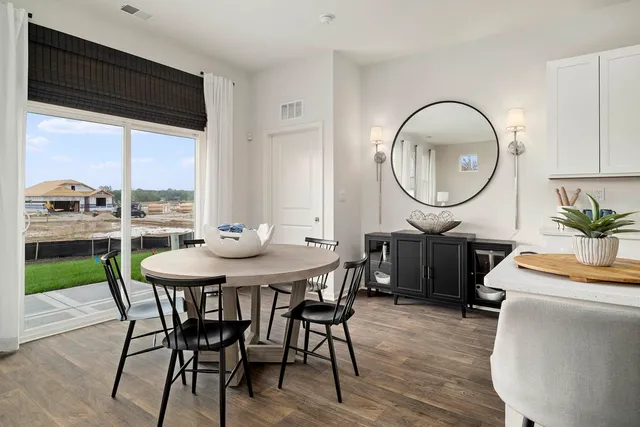 a kitchen with a table chairs sink and cabinets