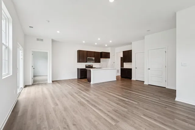 a view of a kitchen with a sink and a refrigerator