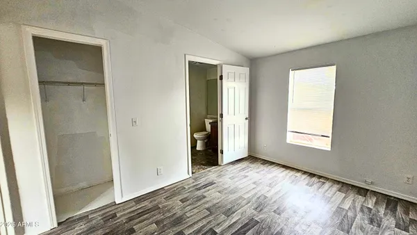 a view of a bedroom with wooden floor