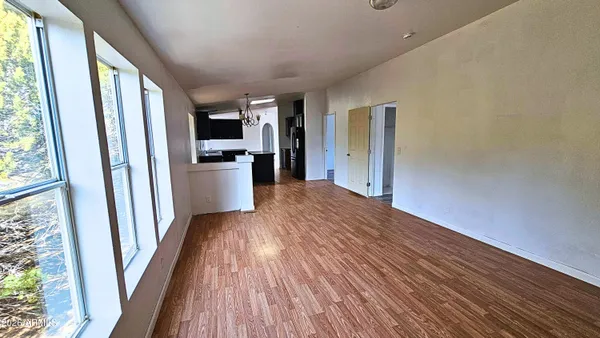 a view of a kitchen from a hallway