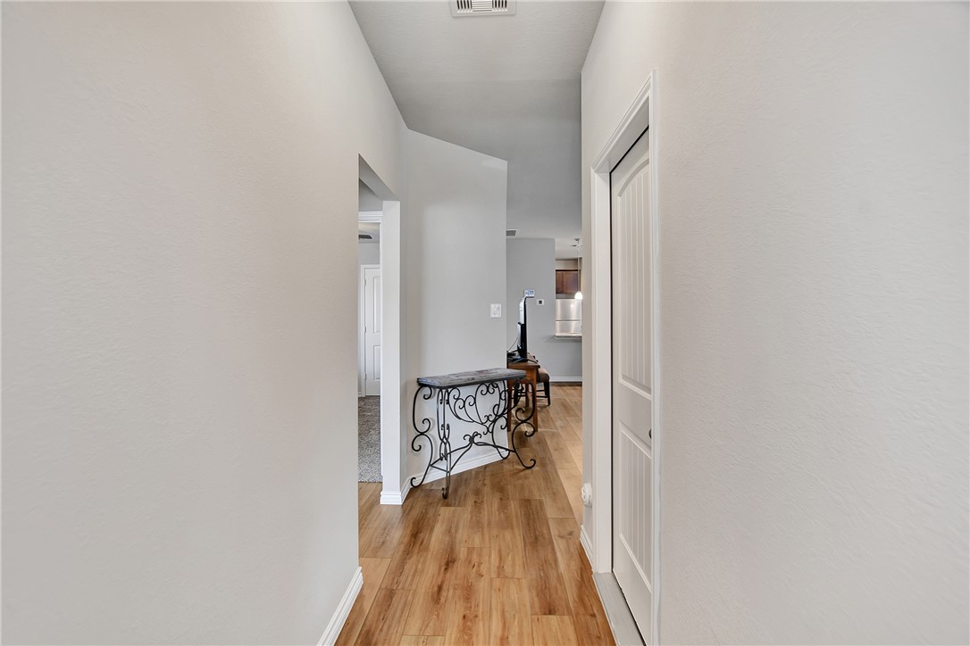 909 Davy Street Brenham, TX 77833 - Photo 6 of 35 Corridor with baseboards and light wood-style flooring