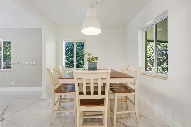 a view of a dining room with furniture wooden floor and a chandelier