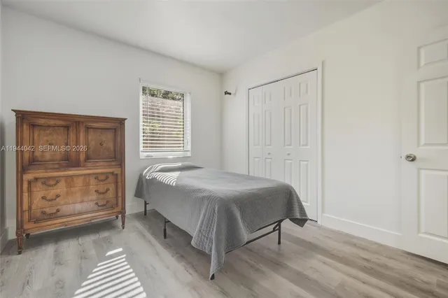 a bedroom with a bed and closet
