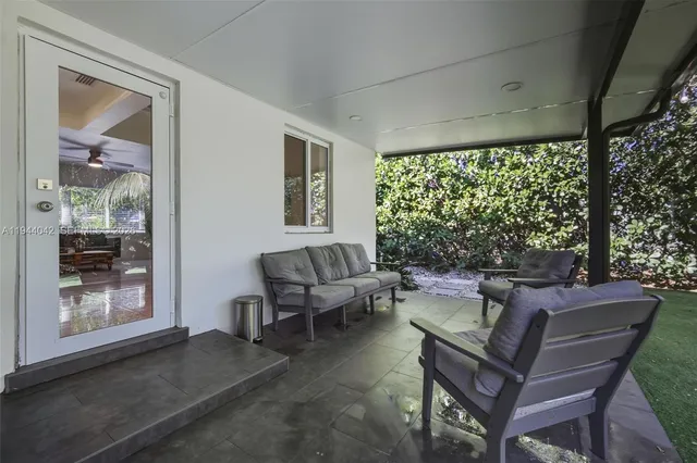 a living room with furniture and a large window
