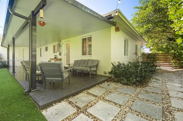 a view of a patio with table and chairs and potted plants