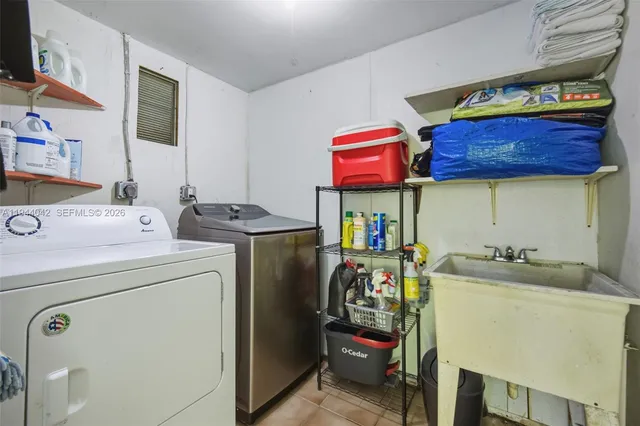 an aerial view of a house with a yard and garden in the back