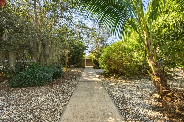 a view of a pathway both side of house
