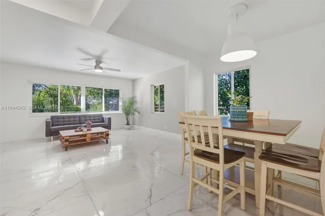 a view of a dining room with furniture window and outside view