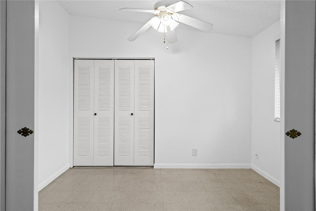 Undisclosed Address Boca Raton, FL 33428 - Photo 17 of 35 a view of an empty room with a fan
