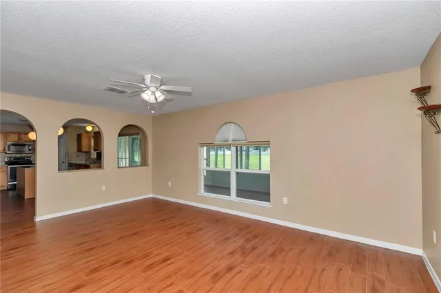 a view of livingroom with hardwood floor and ceiling fan