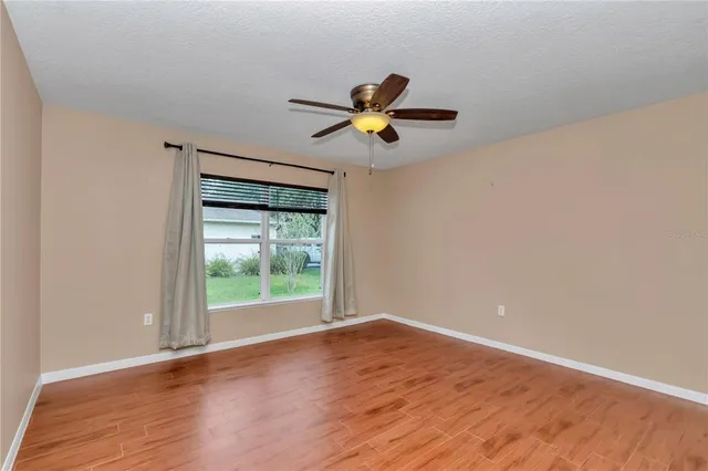 a view of a room with wooden floor and white walls
