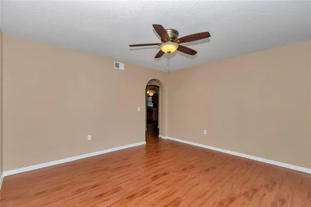 a view of staircase with wooden floor and white walls