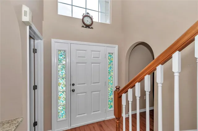 a view of a hallway with wooden floor and staircase