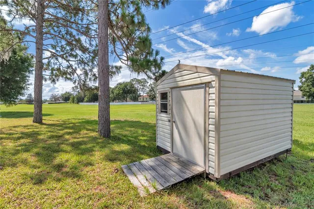an aerial view of a house with a yard and lake view