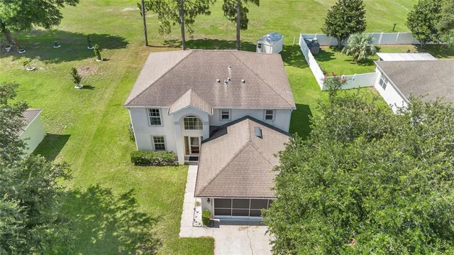 a view of a house with a backyard