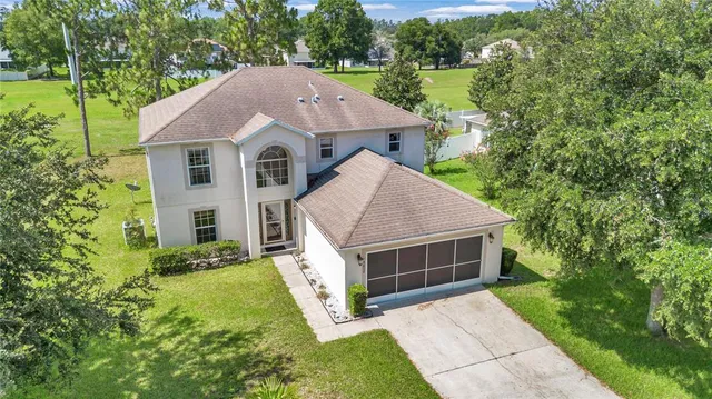 a view of house with swimming pool and sitting area