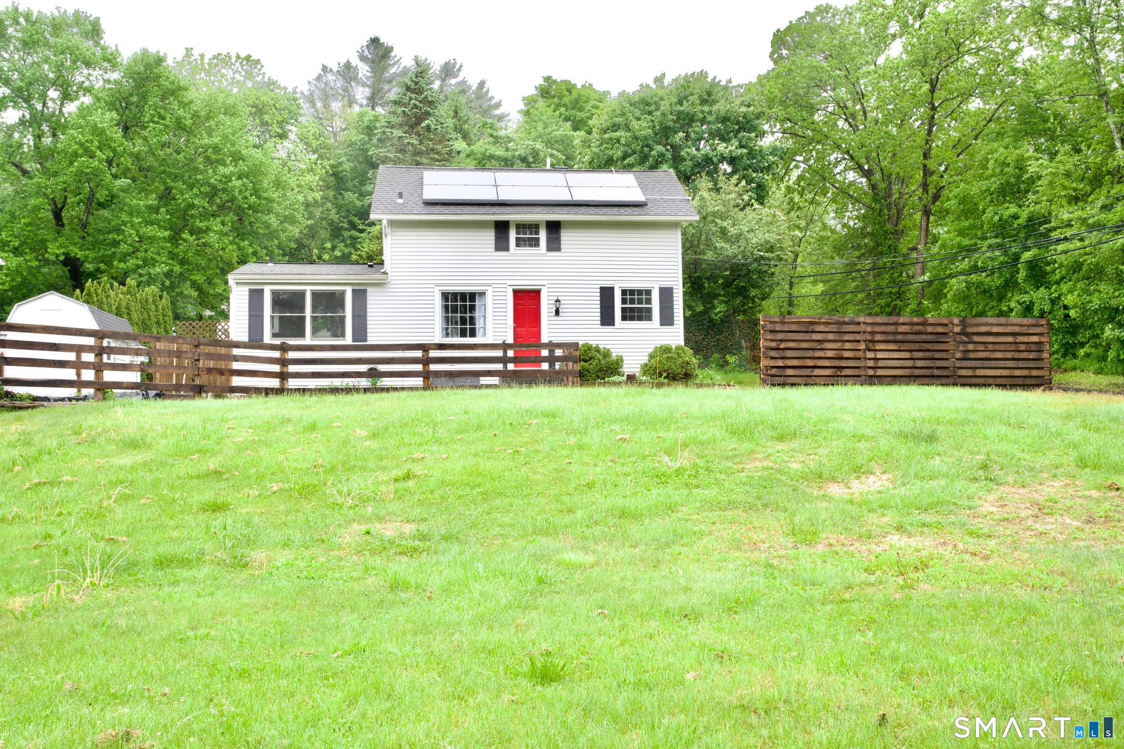 259 Peck Hill Road Woodbridge, CT 06525 - Photo 1 of 32 a front view of a house with a garden and trees