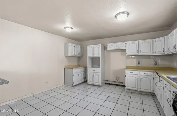 a kitchen with granite countertop cabinets and stainless steel appliances