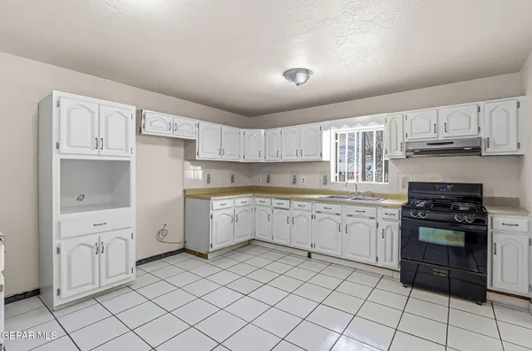 a kitchen with granite countertop cabinets and steel stainless steel appliances