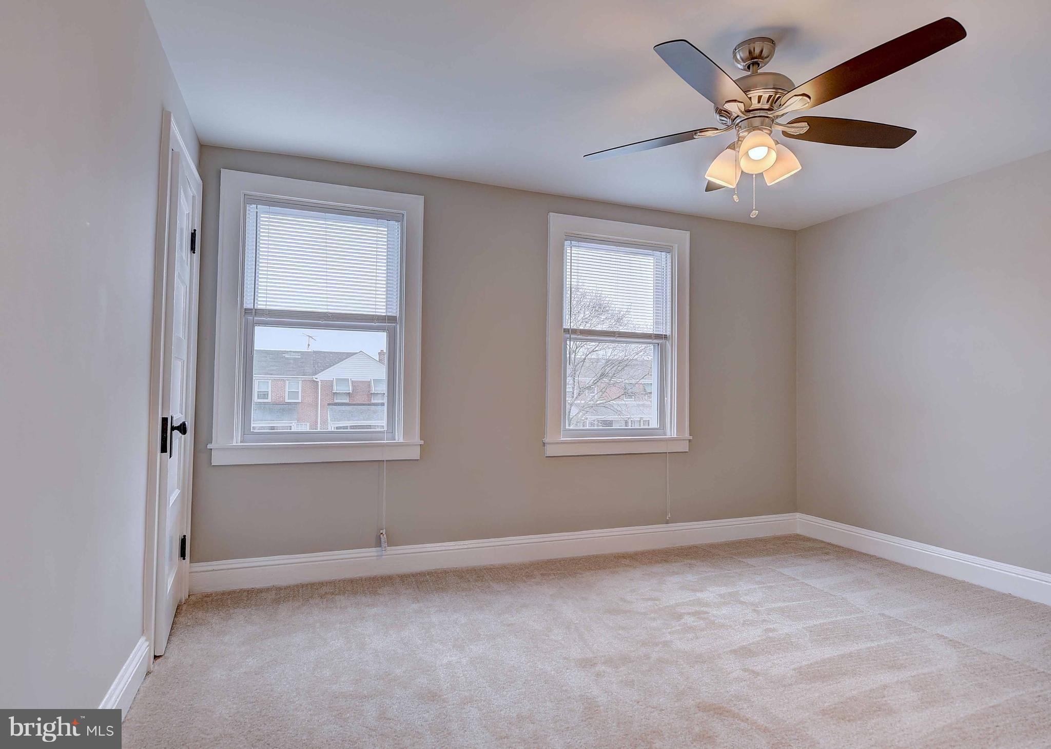 6830 Belclare Road Baltimore, MD 21222 - Photo 14 of 23 an empty room with windows and fan