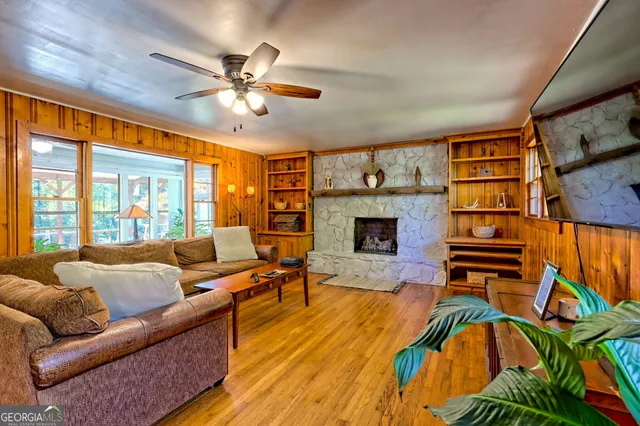 a living room with furniture a fireplace and a flat screen tv