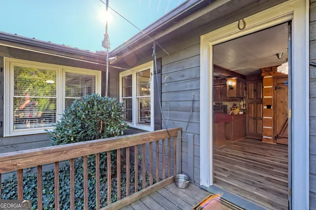a very nice looking room with a large window and wooden floor