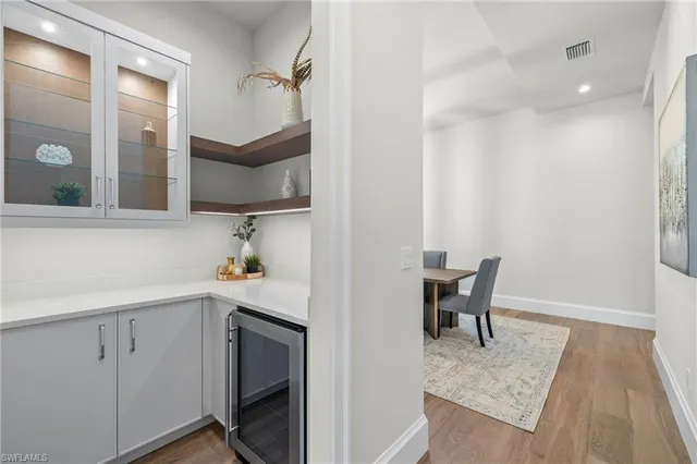 a kitchen with a sink a table and chairs in it