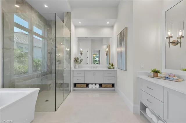 a bathroom with a double vanity sink mirror and shower