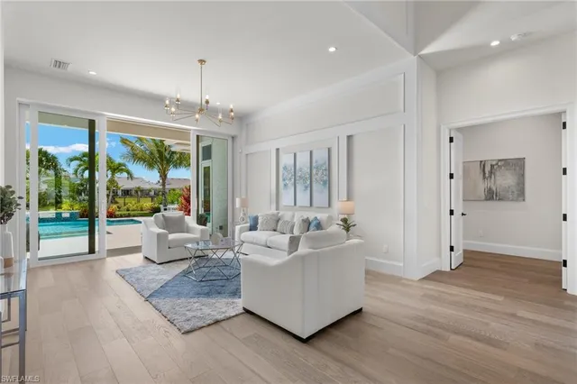a living room with furniture and large windows