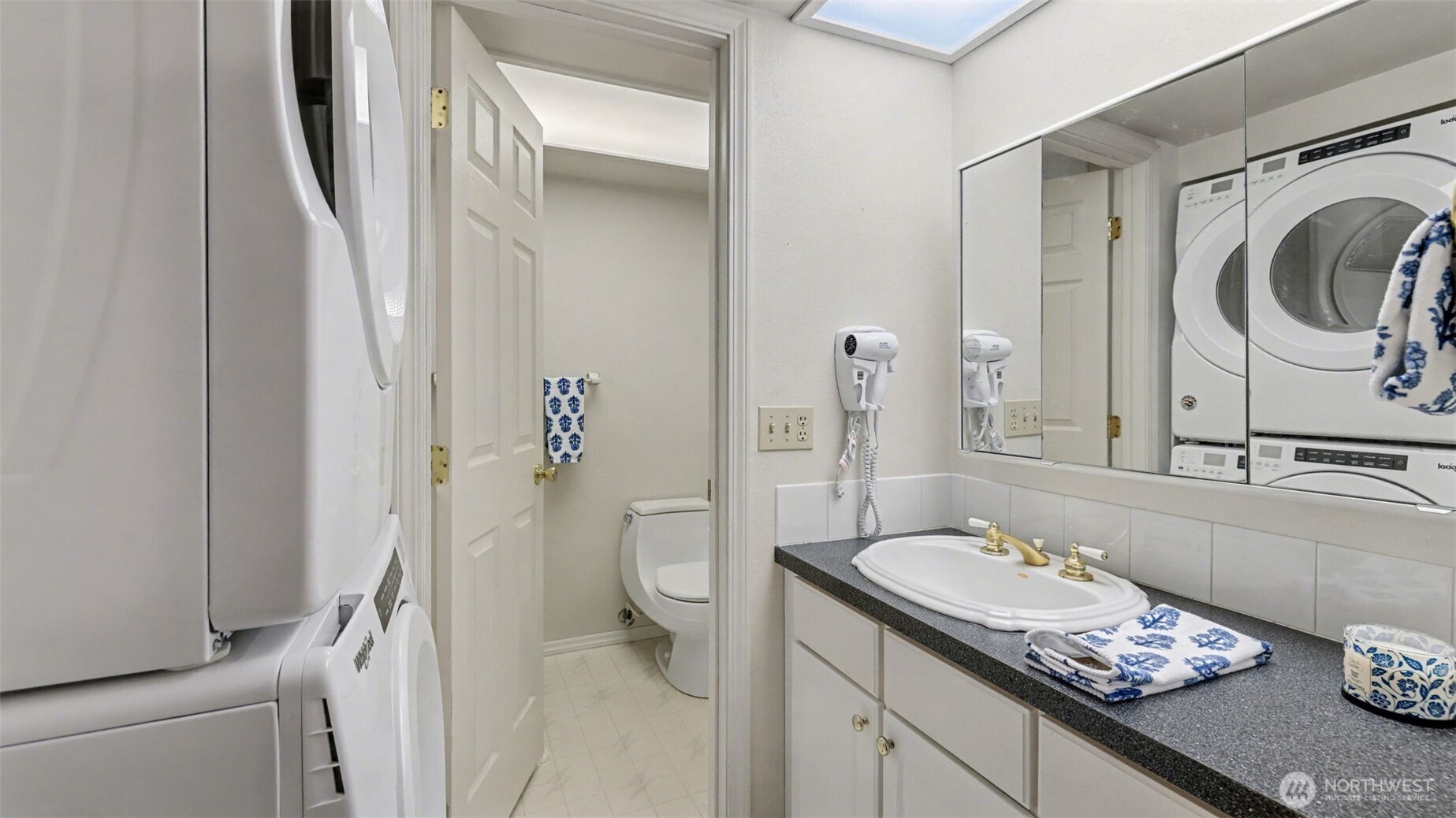 16012 Southeast 172nd Place Renton, WA 98058 - Photo 17 of 31 a bathroom with a granite countertop sink a toilet and a mirror