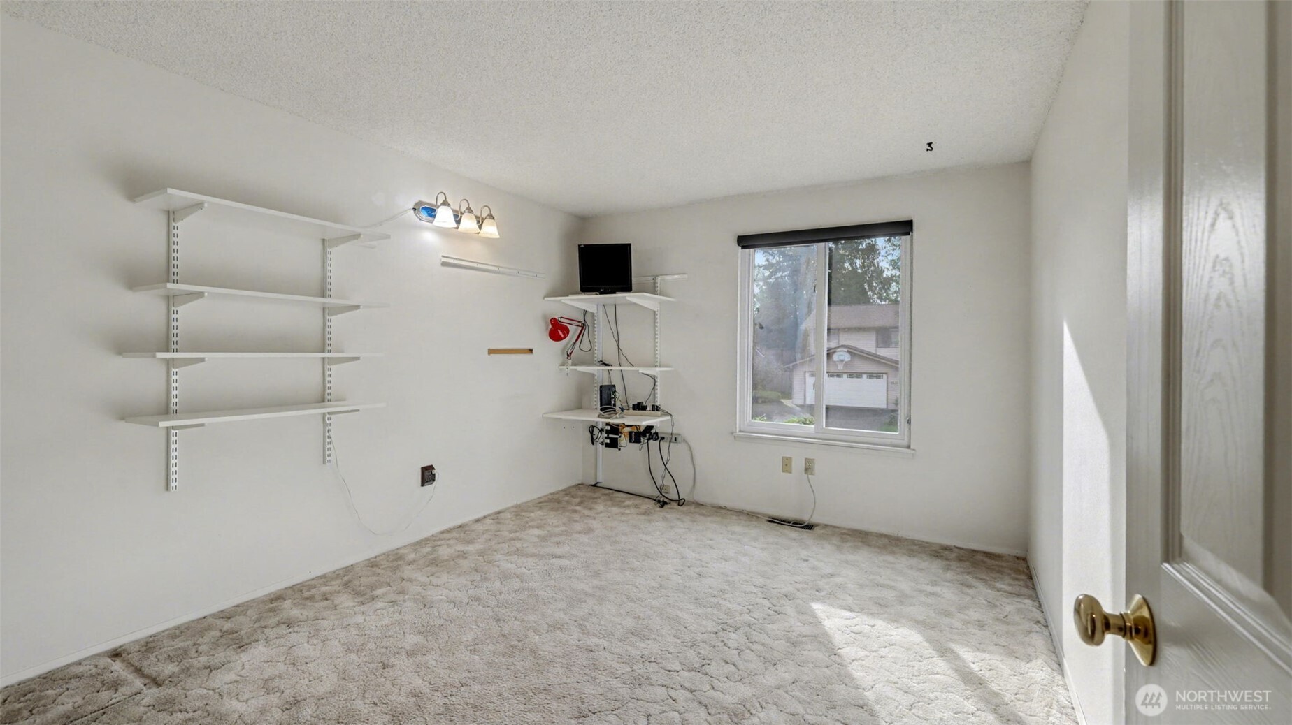 16012 Southeast 172nd Place Renton, WA 98058 - Photo 19 of 31 a view of empty room with window and ceiling fan