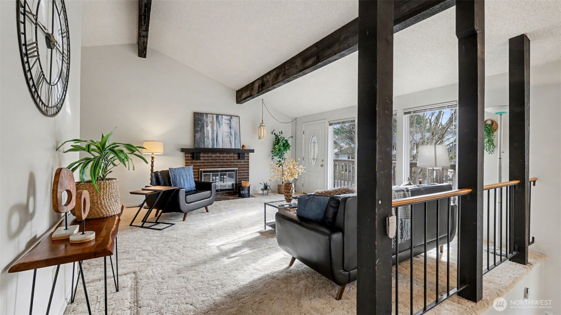 16012 Southeast 172nd Place Renton, WA 98058 - Photo 3 of 31 a living room with furniture a fireplace and potted plants with wooden floor