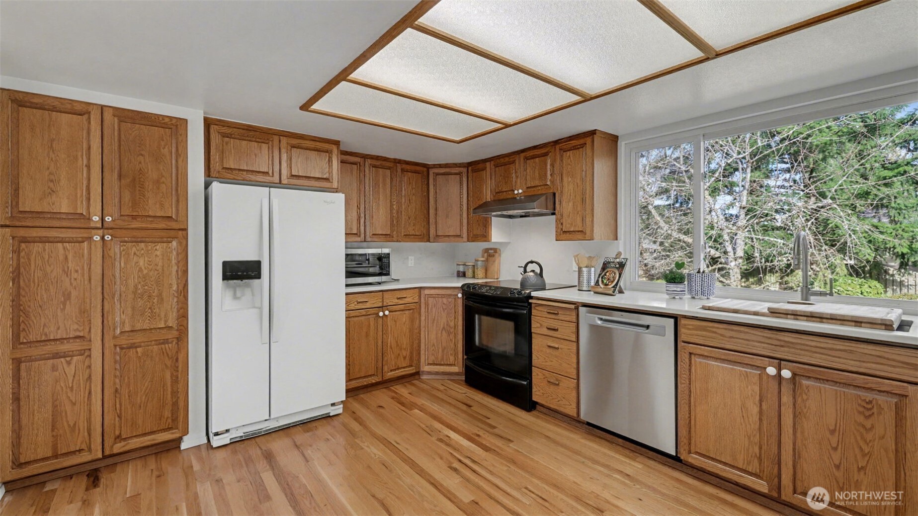 16012 Southeast 172nd Place Renton, WA 98058 - Photo 7 of 31 a kitchen with a refrigerator sink and cabinets