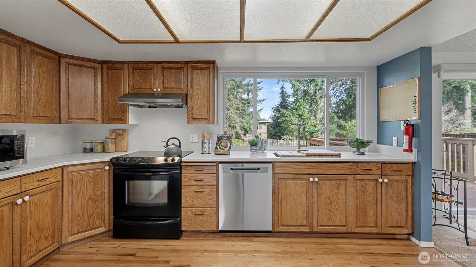 16012 Southeast 172nd Place Renton, WA 98058 - Photo 8 of 31 a kitchen with stainless steel appliances granite countertop a sink a stove a refrigerator cabinets and wooden floor