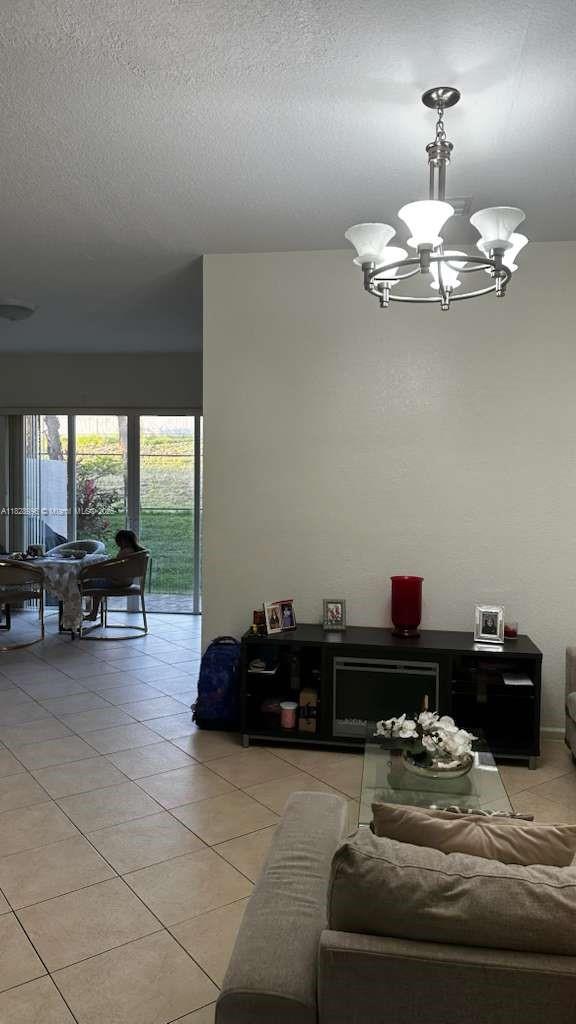 12415 Southwest 42nd Street Miramar, FL 33027 - Photo 13 of 50 a living room with furniture and a chandelier