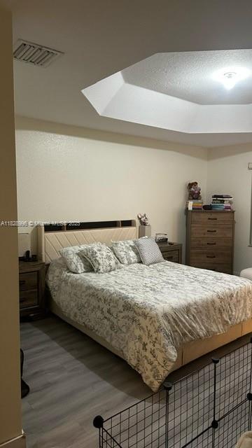 12415 Southwest 42nd Street Miramar, FL 33027 - Photo 16 of 50 a bedroom with a bed and wooden floor