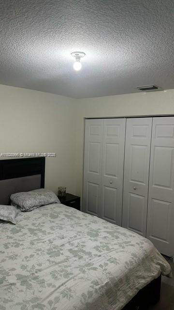 12415 Southwest 42nd Street Miramar, FL 33027 - Photo 20 of 50 a bedroom with a bed and a dresser