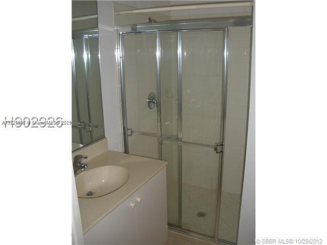 12415 Southwest 42nd Street Miramar, FL 33027 - Photo 28 of 50 a bathroom with a granite countertop sink a mirror and shower