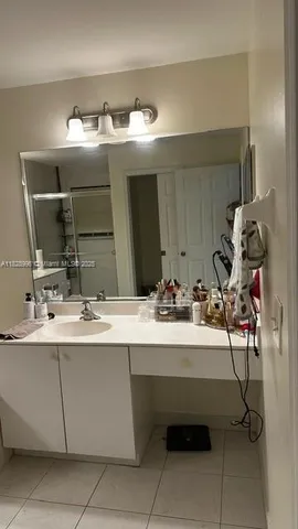 a bathroom with a shower sink and mirror