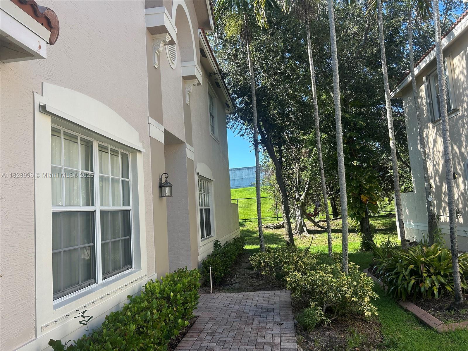 12415 Southwest 42nd Street Miramar, FL 33027 - Photo 32 of 50 a view of a house with a garden