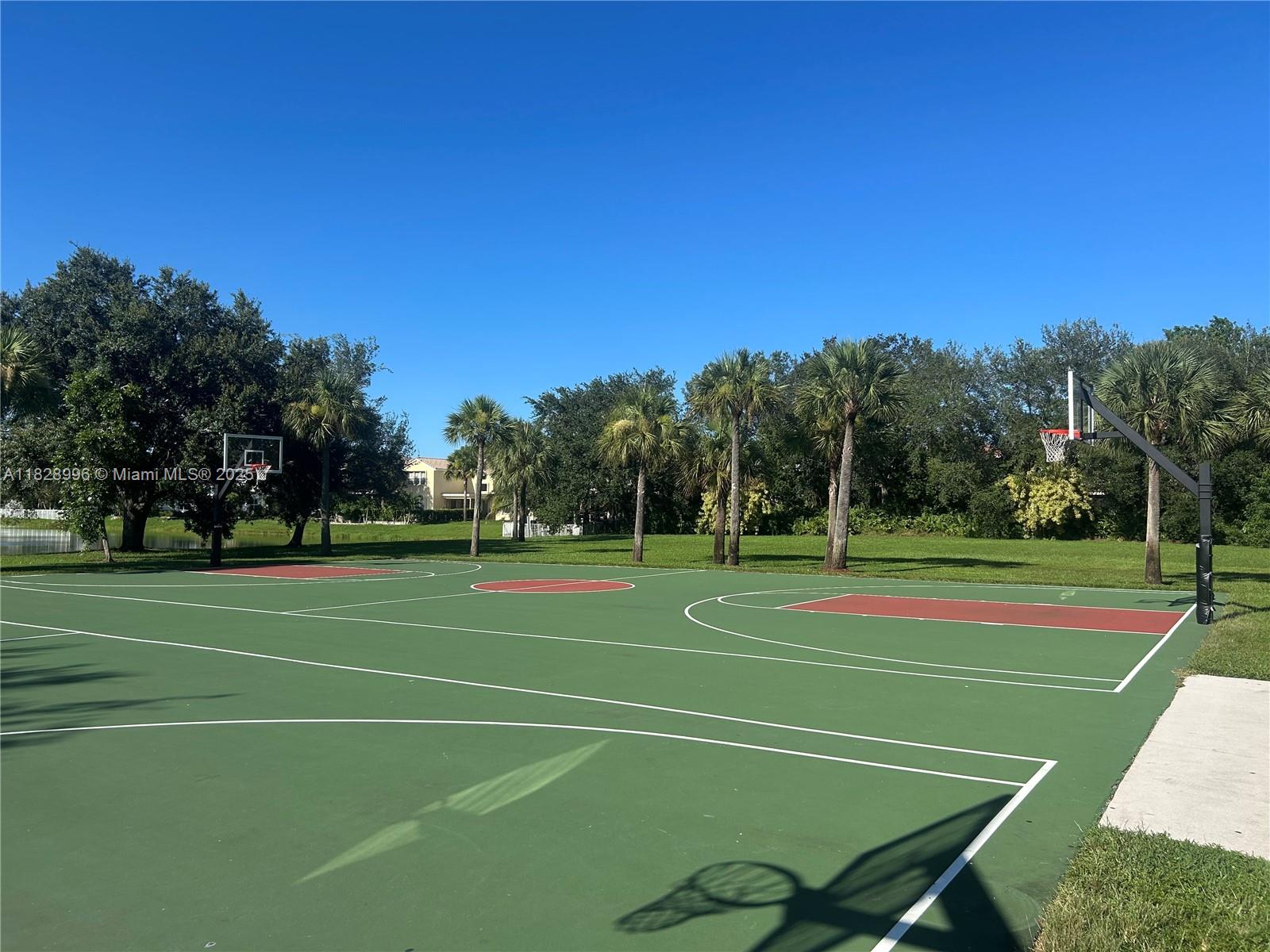 12415 Southwest 42nd Street Miramar, FL 33027 - Photo 47 of 50 a tennis court with trees in the background