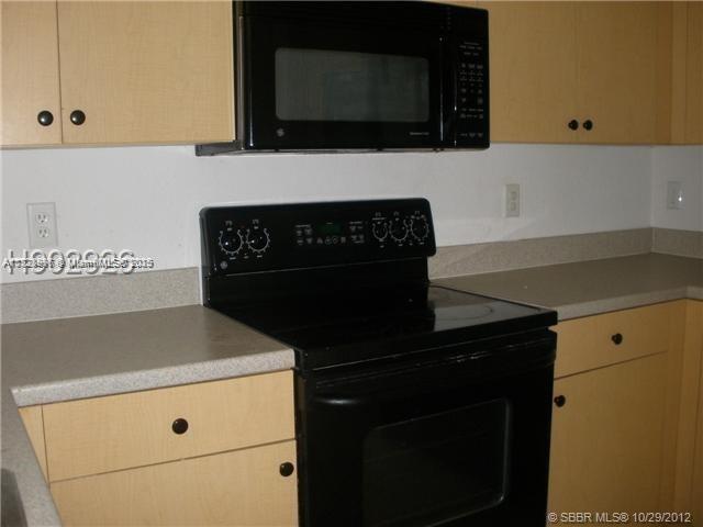 12415 Southwest 42nd Street Miramar, FL 33027 - Photo 8 of 50 a kitchen with a stove and a microwave
