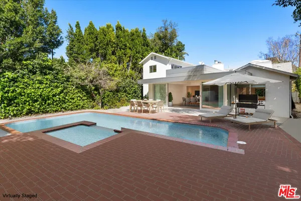 swimming pool view with a seating space