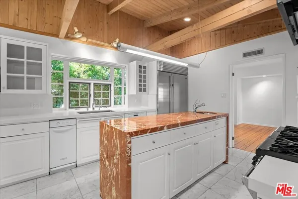 a kitchen with a sink stove and cabinets